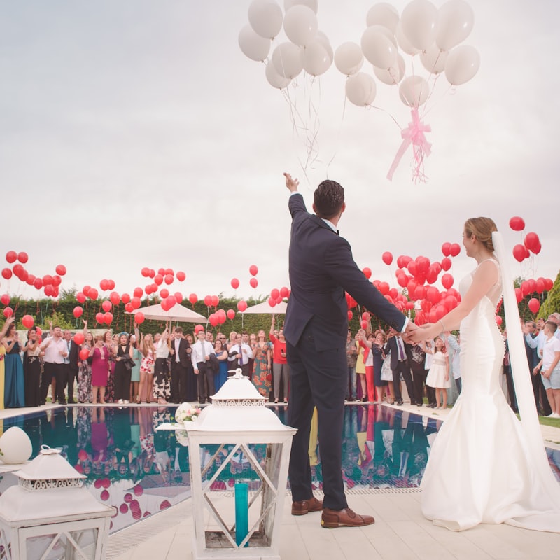 Outdoor forest wedding ceremony with wooden arch and guests seated on benches