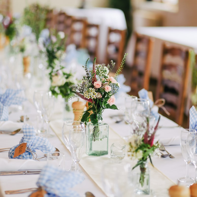 Outdoor reception with long tables and string lights in a meadow